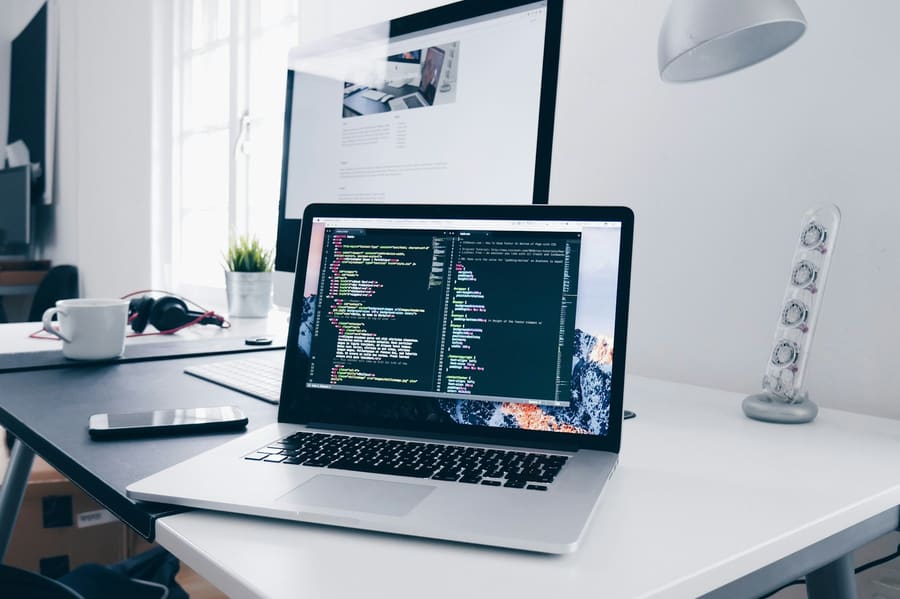 Laptop with code on a clean developer desk